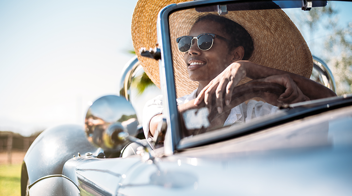 Woman driving a car smiling