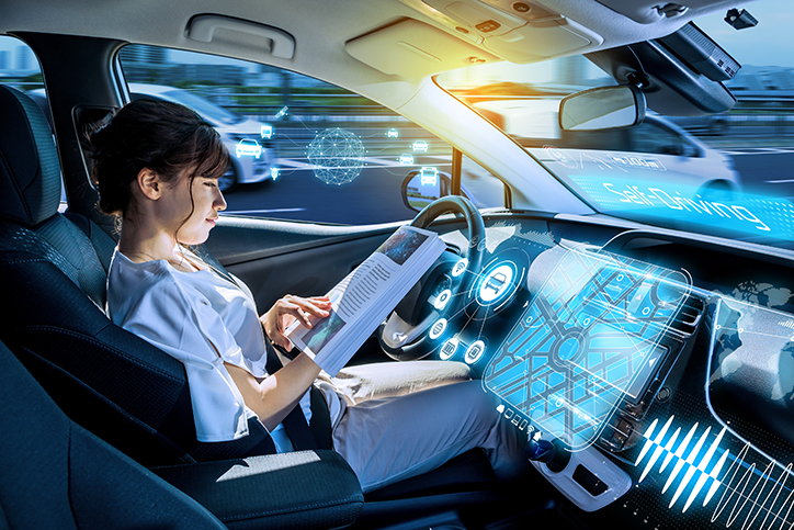 Woman reading a magazine in a autonomous car. driverless car. self-driving vehicle. heads up display. automotive technology.