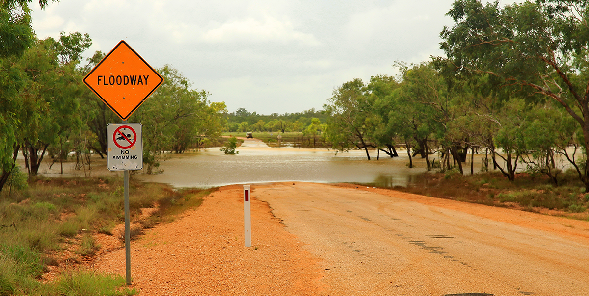 Flooded road and Floodway sign